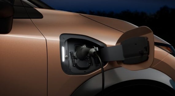 Close-up image of charging cable plugged in | Crown Nissan in St. Petersburg FL